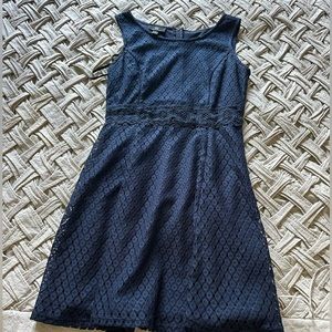 Navy sleeveless mini dress with lace detail. Size M